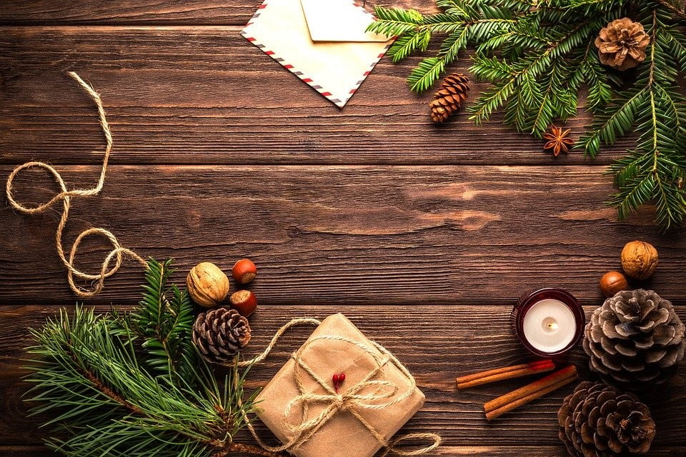 an aerial shot of christmas decorations on a wooden table