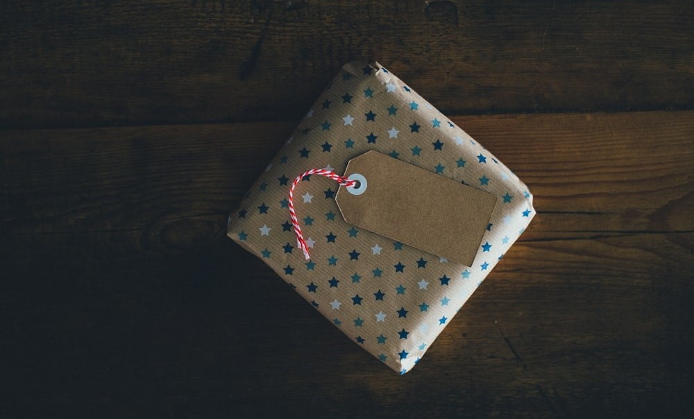 a gift in golden wrapping paper with blue stars