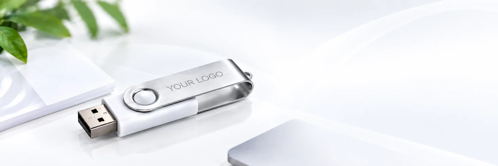 Branded Twister USB stick with your logo on a white desk